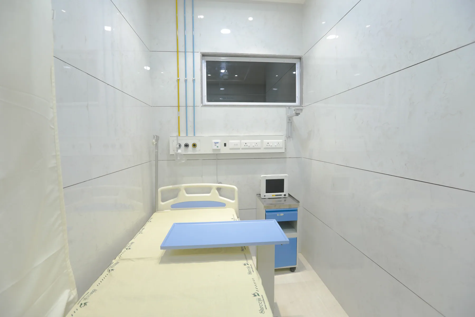 Private patient room with bedside monitor