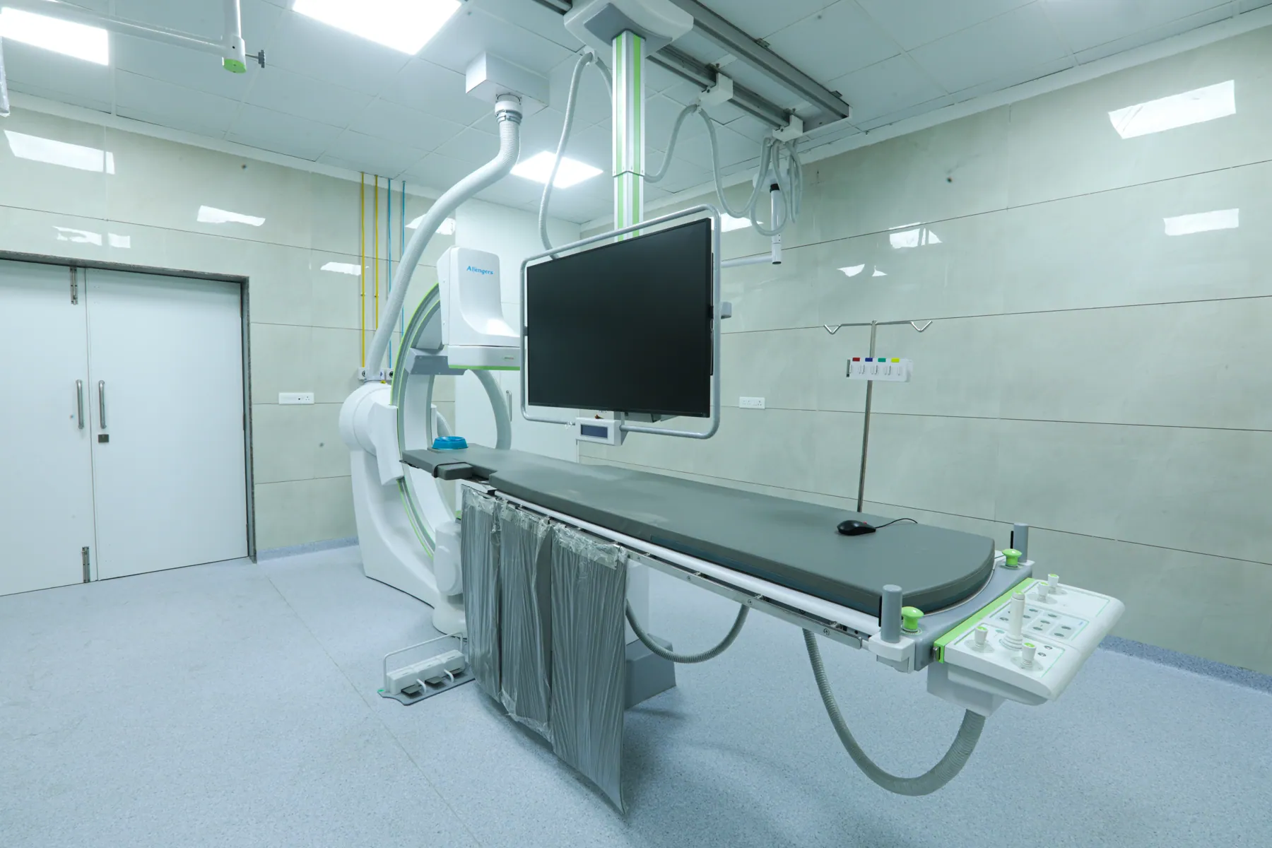 Imaging-guided procedure room with C-arm system